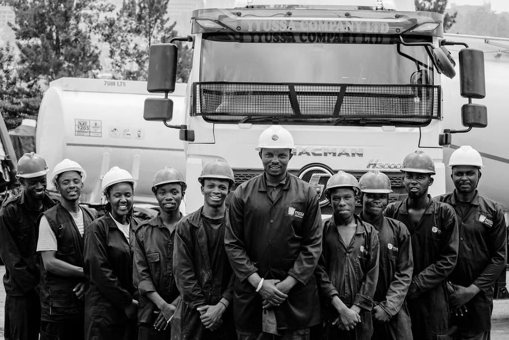 YYUSSA logistics crew in front of a branded tank trailer